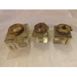 One large and two small clear cut glass square formed Inkwells with plated mounts