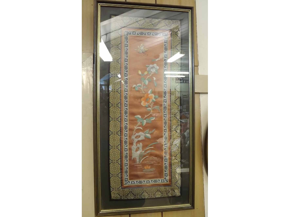 An Oriental Silk Framed Mandarin Sleeve, embroidered with central panel of butterfly and foliage,