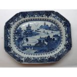 A Nankin Platter, typically decorated in underglaze blue with a Chinese river scene within a