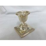 A small George V Silver Dressing Table Candlesticks, raised on a square loaded base, hallmarked