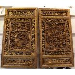 A pair of Decorative 20th Century Oriental Gilded and Carved Panels with scroll moulded borders