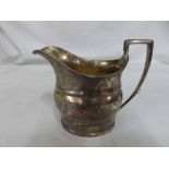 A George III Silver Milk Jug, of plain form with looped handle, hallmarked London 1801, weight 5 oz