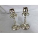 A pair of early 20th Century Silver Candlesticks, the knopped stems over spreading circular loaded