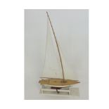 Bowman models Pond Yacht with maroon and white painted hull, polished deck with twin rigged sails,