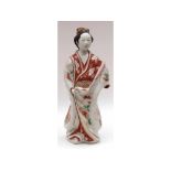 A Japanese Imari/Kutani Figure of a serving girl wearing traditional dress (hair comb repaired),