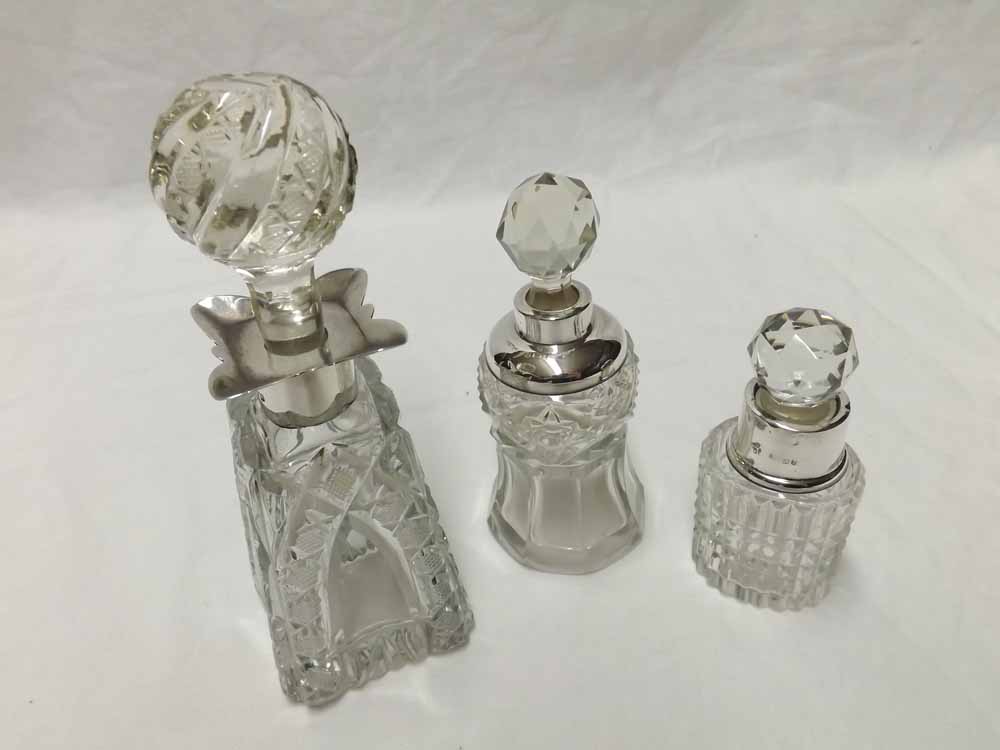 A group of three cut glass and Silver mounted Scent Bottles, one of tapering square form with