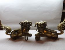 A pair of heavy Chinese Gilded Bronze Firedogs, modelled as Dogs of Fo (Temple Dogs), one moulded