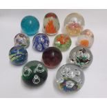 A collection of twelve various globular and conical Paperweights includes one scramble example,