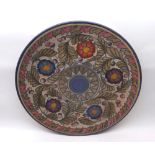 A Charlotte Rhead Circular Plate, typically tube-lined and decorated with stylised flowers on a