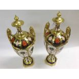 Pair of Royal Crown Derby two-handled ornamental Urns typically decorated in Imari colours with