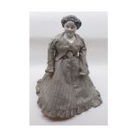 A Porcelain Head and Shoulder Plate Doll with painted facial features, moulded black hair, on
