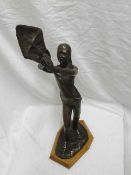 A Bronze effect Study of a woman with a kite, 23 1/2" high   40-50