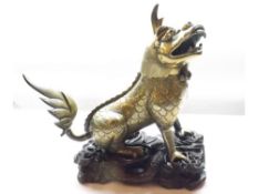 A Chinese Gilded Bronze Incense Burner, modelled as a seated Temple Dog with hinged neck, raised