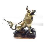 A Chinese Gilded Bronze Incense Burner, modelled as a seated Temple Dog with hinged neck, raised