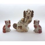 A large 19th Century Staffordshire Copper Lustre decorated Model Spaniel, together with a pair of