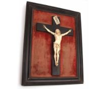 A 19th Century Bone or Composition Crucifix with figure of Christ on the Cross in an ebonised frame,