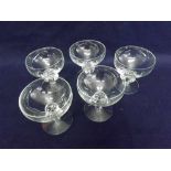 A set of five small Drinking Glasses with wrythen moulded stems and spreading circular bases, 4"