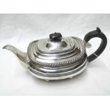 George V Tea Pot of slightly compressed oval form, with gadrooned rim, ebonised handle and finial,