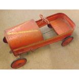 A mid-20th Century Tri-Ang Red Painted Tin Pedal Car (pitting to body work and splits in rubber