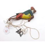 An early 20th Century tin plate climbing monkey toy