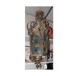 An early 20th Century Brass Hanging Lamp of lantern form, inset with coloured leaded glass panels