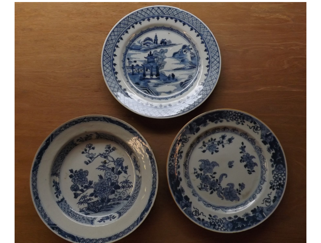 A Nankin Bowl and two Plates, each decorated in underglaze blue with various designs, all 9"