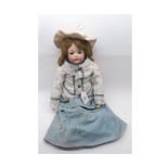 An early 20th Century German Bisque Socket Head Doll, with fixed brown glass eyes, painted lashes