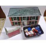 A 1950s Mettoy tin plate lithographed doll's house with side garage section, open back to reveal