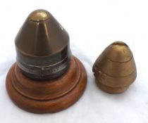 German Shell Cap marked "Dopp Z92 f 10 CMK SP", mounted on wooden socle + one other shell cap (2)