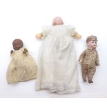 A collection of three small Dolls to include: a Bisque Soldier Doll; Black Baby Doll and a German