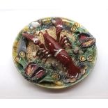 A 20th Century Grotesque type Majolica Plate, decorated with lobster and sea-shells etc, in