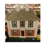 A mid-20th Century Hamleys doll's house with single opening front section to reveal four rooms on
