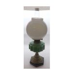 A Victorian Oil Lamp, green font over a gilded support terminating in a black base, 22" high