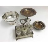 A Mixed Lot comprising: a late 19th or early 20th Century Silver Plated Cruet Stand containing six