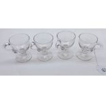 A set of four 19th Century Clear Glass Custard Cups of typical form with looped handles, 3 ¼”