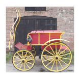 A vintage wheel Dog Cart with black metal frame and spoked wheels, painted in yellow and red,