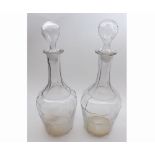 A pair of 19th Century Large Clear Glass Decanters fitted with hollow stoppers, over tapering