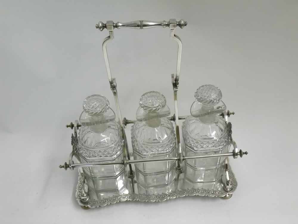 A 19th Century Silver Plated Three Bottle Decanter Stand, with central handle, fitted with three