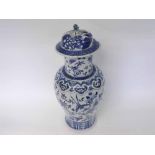 A 19th Century Chinese blue and white decorated covered Baluster Vase decorated with birds, bats and