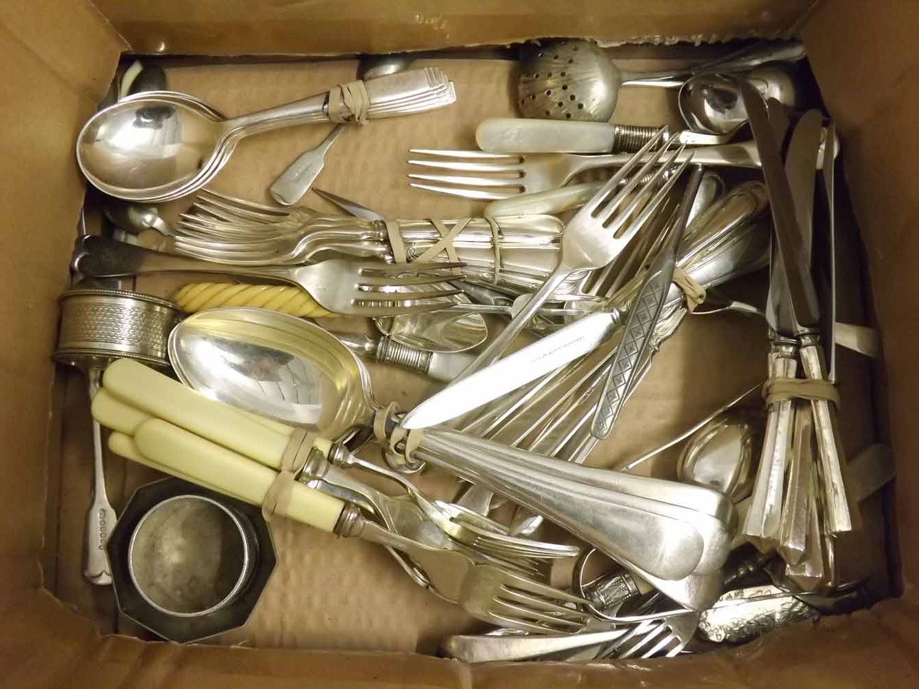 A box of various assorted Silver Plated Cutleries, Napkin Rings, Spirit Cups etc