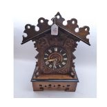 A late 19th Century Oak and ebonised Mantel Cuckoo Clock, the architectural case with carved and