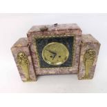 An early 20th Century French predominantly variegated pink and yellow Marble Mantel Clock, the