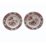 A pair of 18th Century Chinese Plates, the centres painted predominantly in famille rose with floral