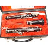 A Boosey & Hawkes Ebonite Oboe with silver plated or chromium fittings, numbered 315531, in a