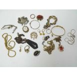 Tin of assorted costume jewellery items including three Rings, Cameo Brooches, Pendants, Bangle,