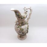 A 20th Century Continental Ewer decorated with cherubs and raised floral detail, scrolled handle (no
