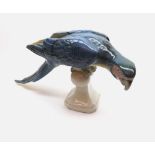 A large 20th Century Continental model of a Macaw raised on perch base, 16” long