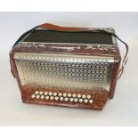 An early 20th Century Becho twenty-five button Accordion, brown marbleised finish inset with green