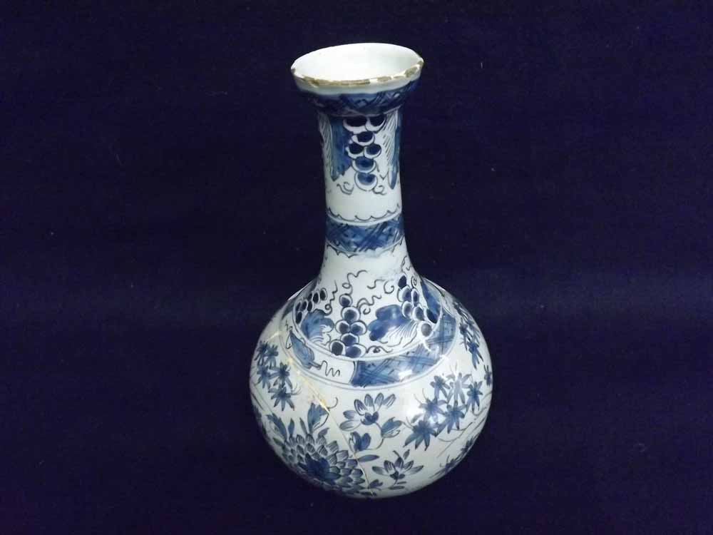 A Delft Baluster Vase decorated throughout in underglaze blue with foliage etc, (extensive repair,