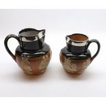 Two Royal Doulton Stoneware Jugs decorated with raised sprigs and fitted with hallmarked Silver